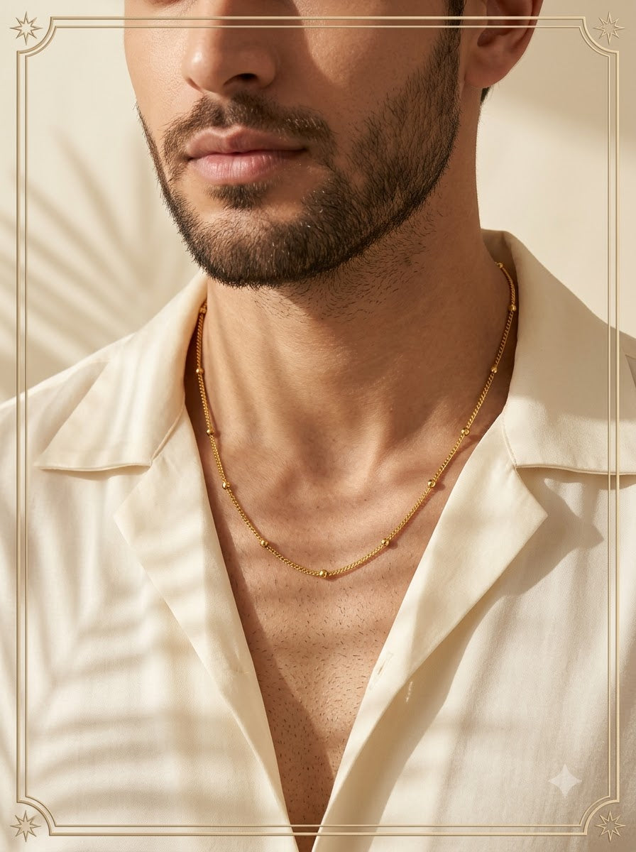 Male model wearing the Stellaris Beaded Chain gold satellite necklace