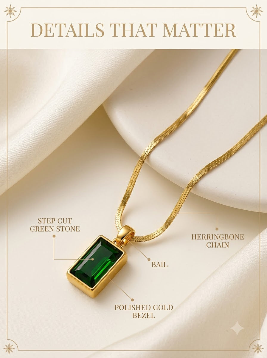 Verdelle Emerald Pendant detail: step cut green stone, polished gold bezel, bail and herringbone chain