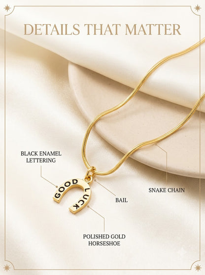 Lucera Horseshoe Pendant detail: black enamel lettering, polished gold horseshoe, bail and snake chain